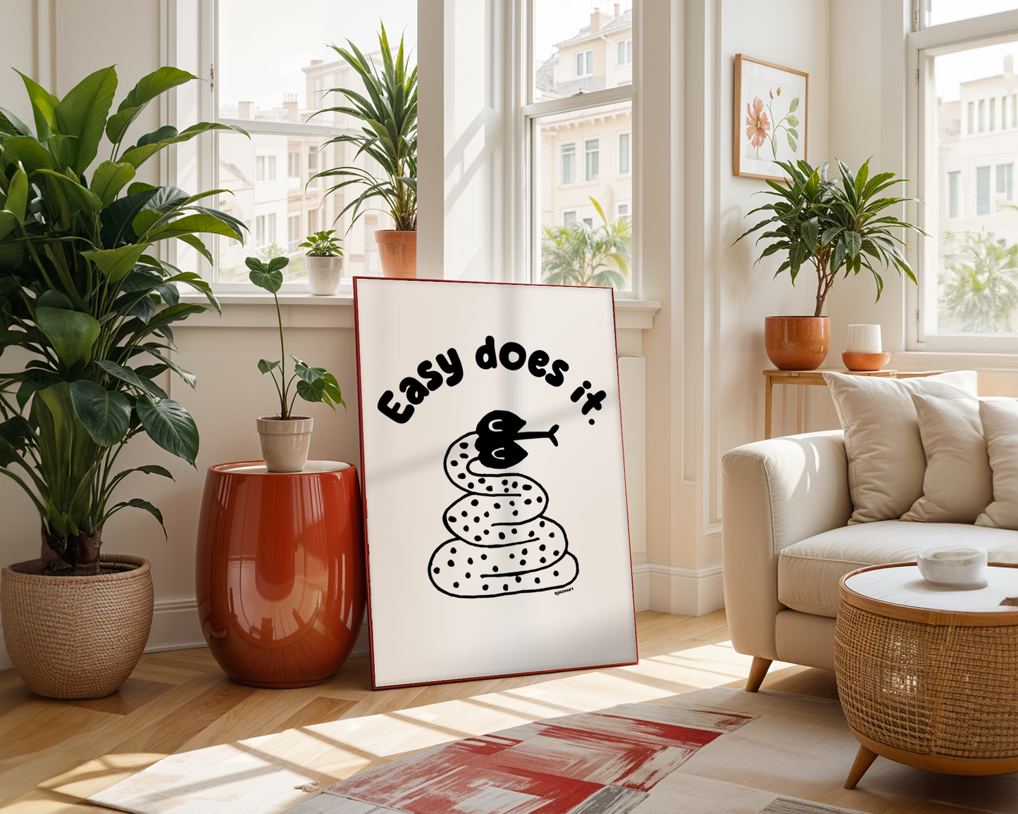 Handwritten thin letters spelling out “Easy Does It.” Illustrated snake character in black on a white background with clean lines. Inspired by the southwest and western United States.
