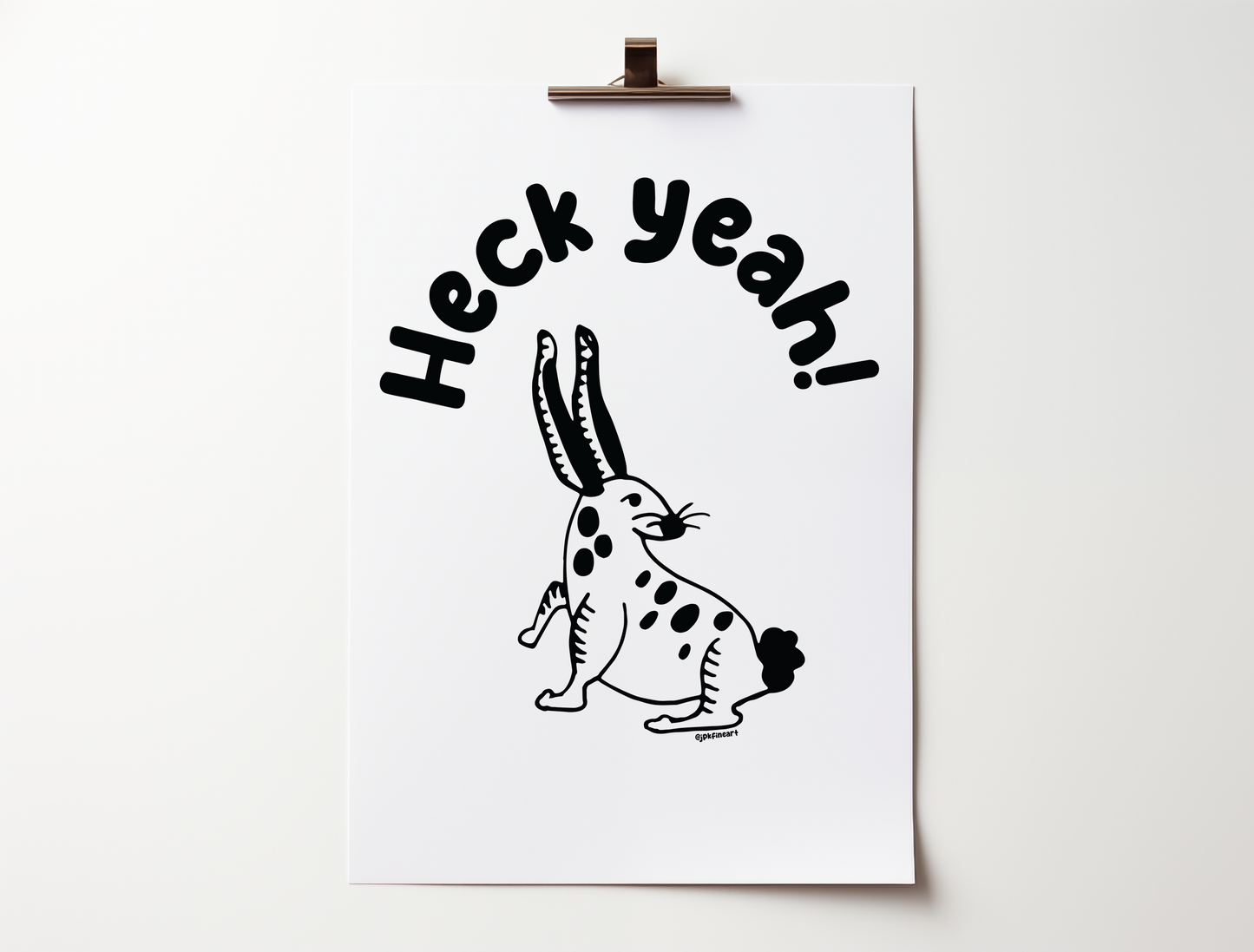 Handwritten bubble letters spelling out “Heck Yeah!” Illustrated rabbit character in black on a white background with clean lines. Inspired by the southwest and western United States.