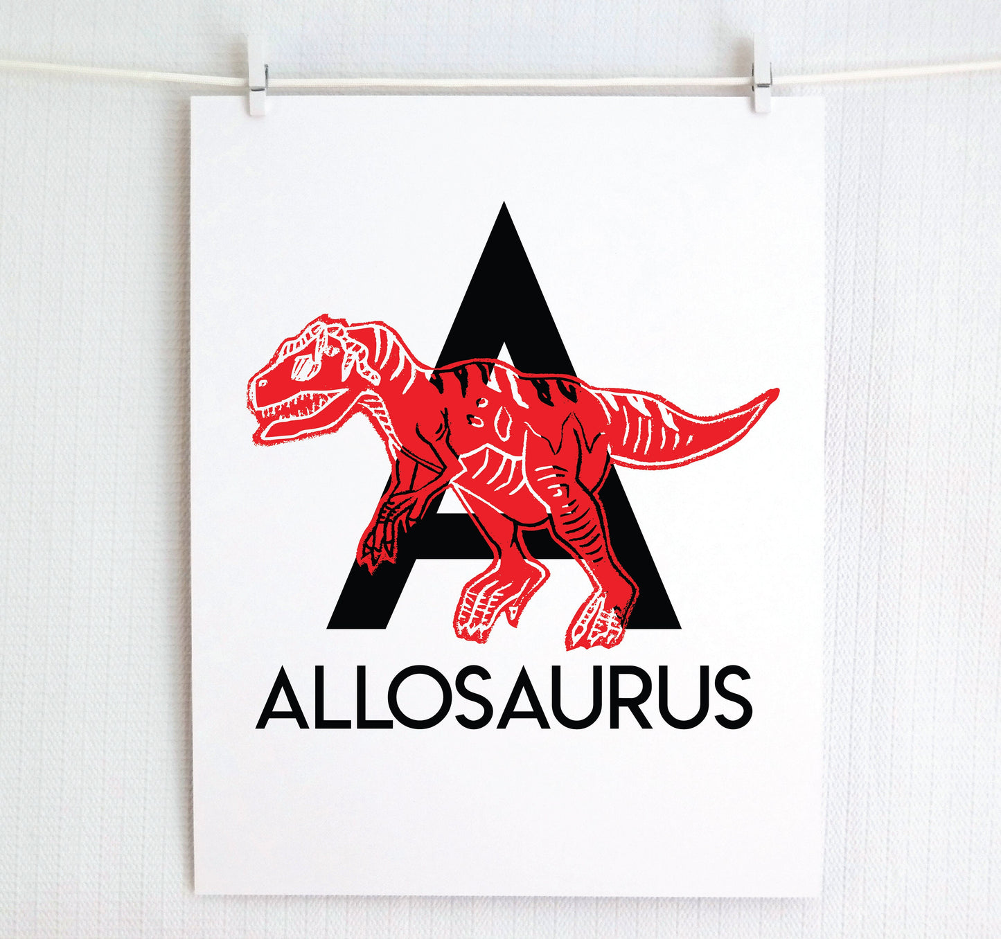 Bold modern letter A in black with “Allosaurus” printed below. Printed dinosaur in color appears over the letter to created an alphabet art print.