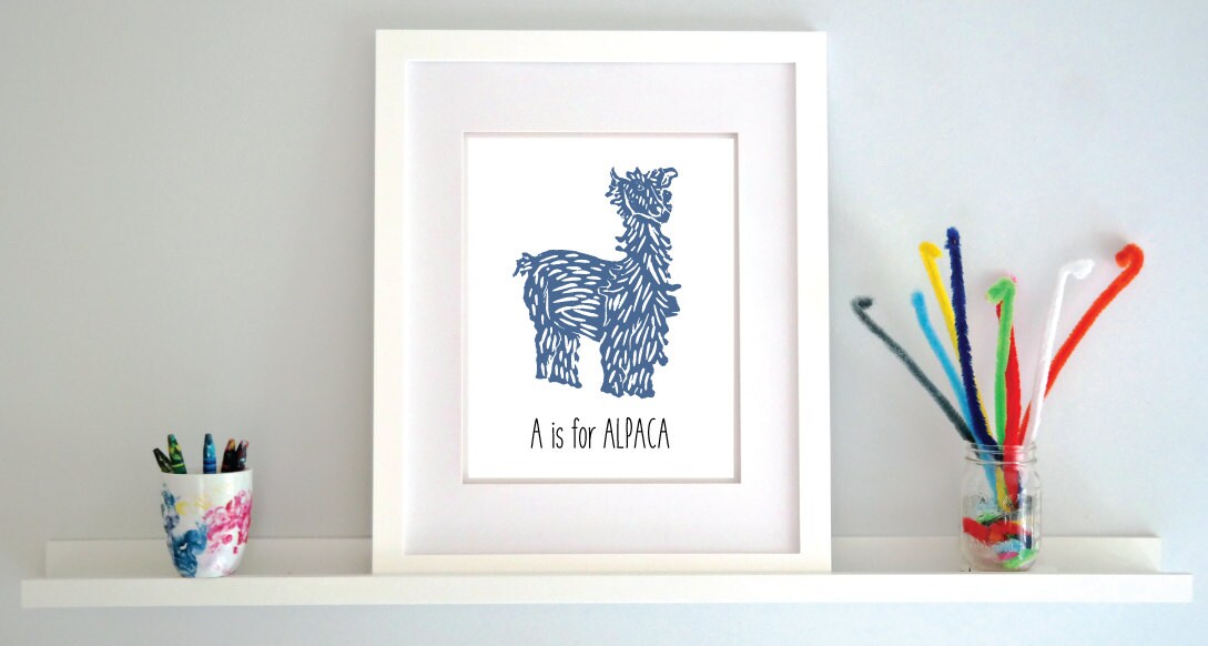 An illustrated alpaca with textured fur stands over hand written style block lettering text that says “A for Alpaca.”