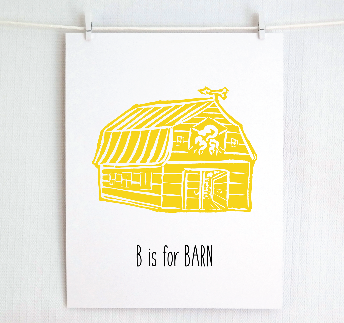An illustrated barn with stands with an open door and arrow weathervane over hand written style, thin block lettering text that says “B for Barn.”
