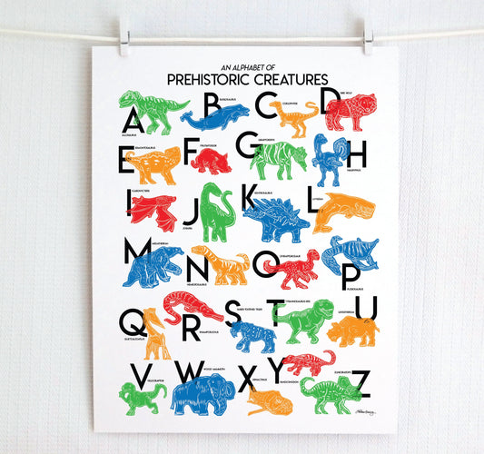 Colorful illustrated prehistoric creatures for every letter of the alphabet printed on a white background. Modern, slim text in black. Color palette is red, green blue, red and orange.