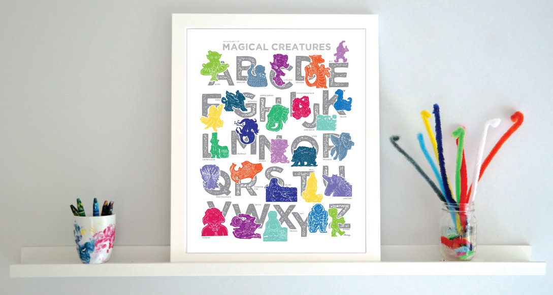 Colorful illustrated magical creatures for every letter of the alphabet printed on a white background. Chunky illustrated letters in gray sit behind each character. Colors are jewel-toned and include pinks and purples, blues and greens, yellows and reds.