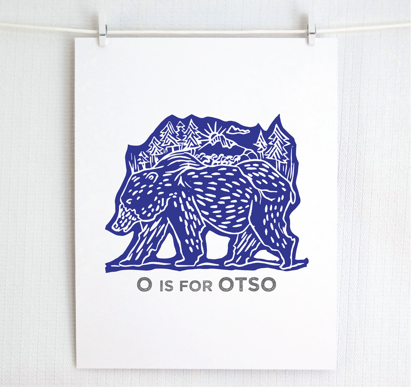 Friendly illustrated bear walking with the forest growing on his back. “O is for Otso” text in a gray block font below.