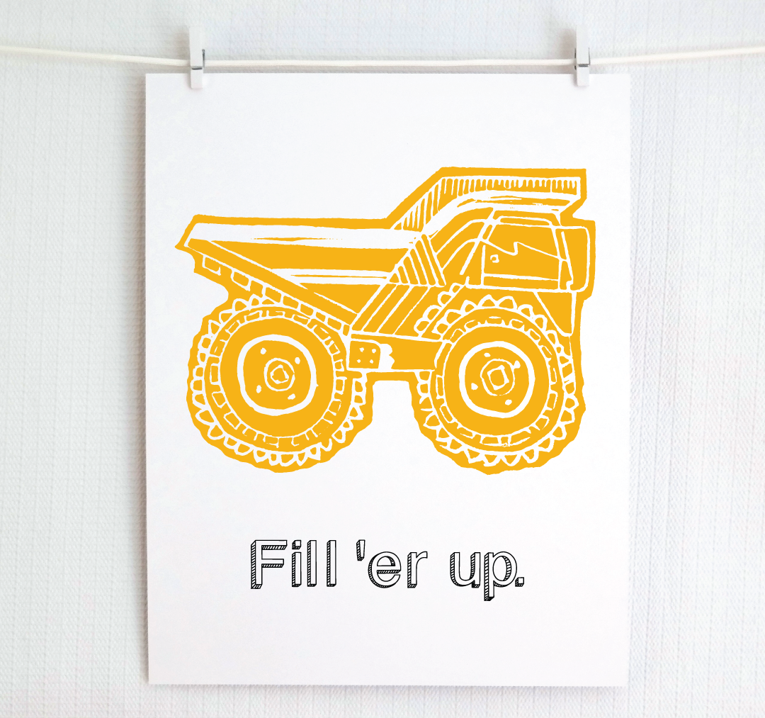 A white art print clipped to a white wall, featuring a yellow block-print style illustration of a dump truck with the text 'Fill 'er up.' underneath.