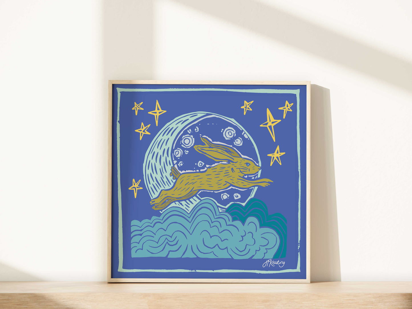 Framed artwork with a rabbit and moon design on a blue background