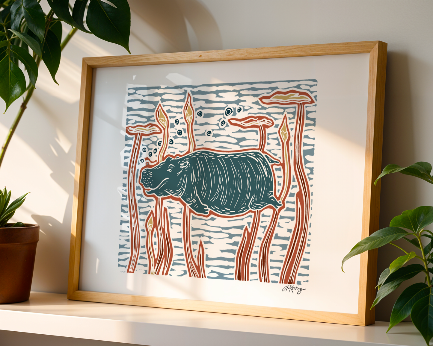 Framed artwork of a stylized hippo with plants on either side.