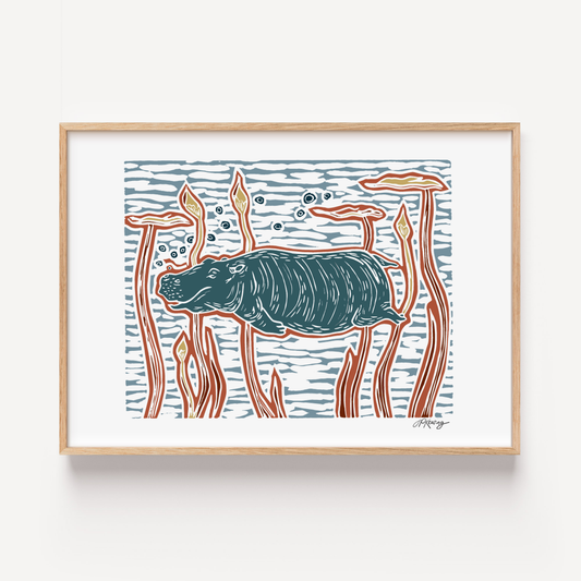 Framed artwork of a stylized hippo among reeds on a white background