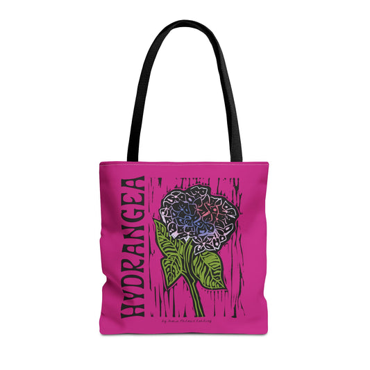 Pink tote bag with hydrangea design and text on a white background