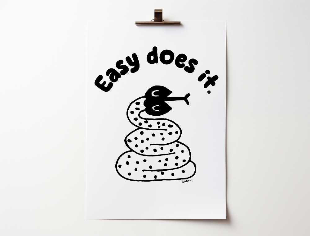 Handwritten thin letters spelling out “Easy Does It.” Illustrated snake character in black on a white background with clean lines. Inspired by the western United States.
