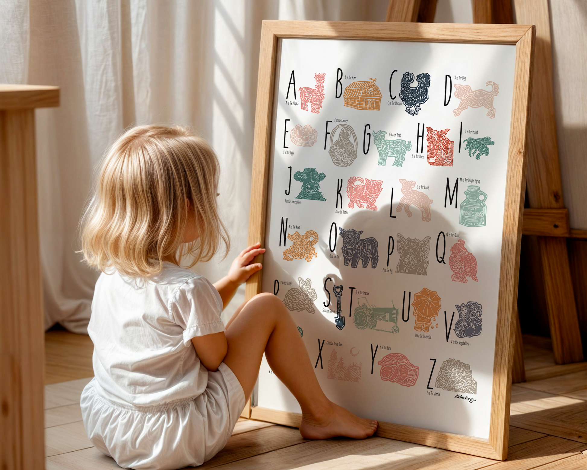 A colorful woodblock print alphabet poster featuring various underwater creatures illustrated alongside each letter.