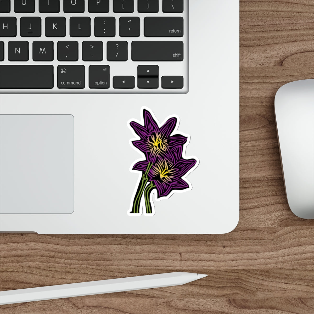 Laptop with a flower sticker on a wooden desk