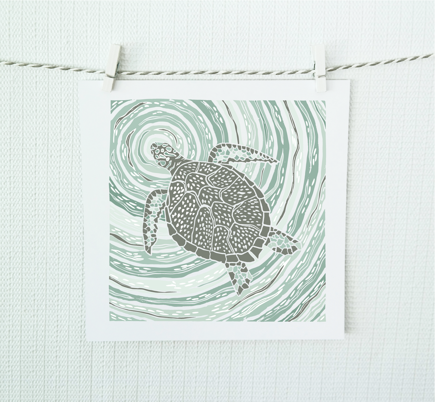 Illustration of a turtle on a wavy green background, hanging on a string against a light background.