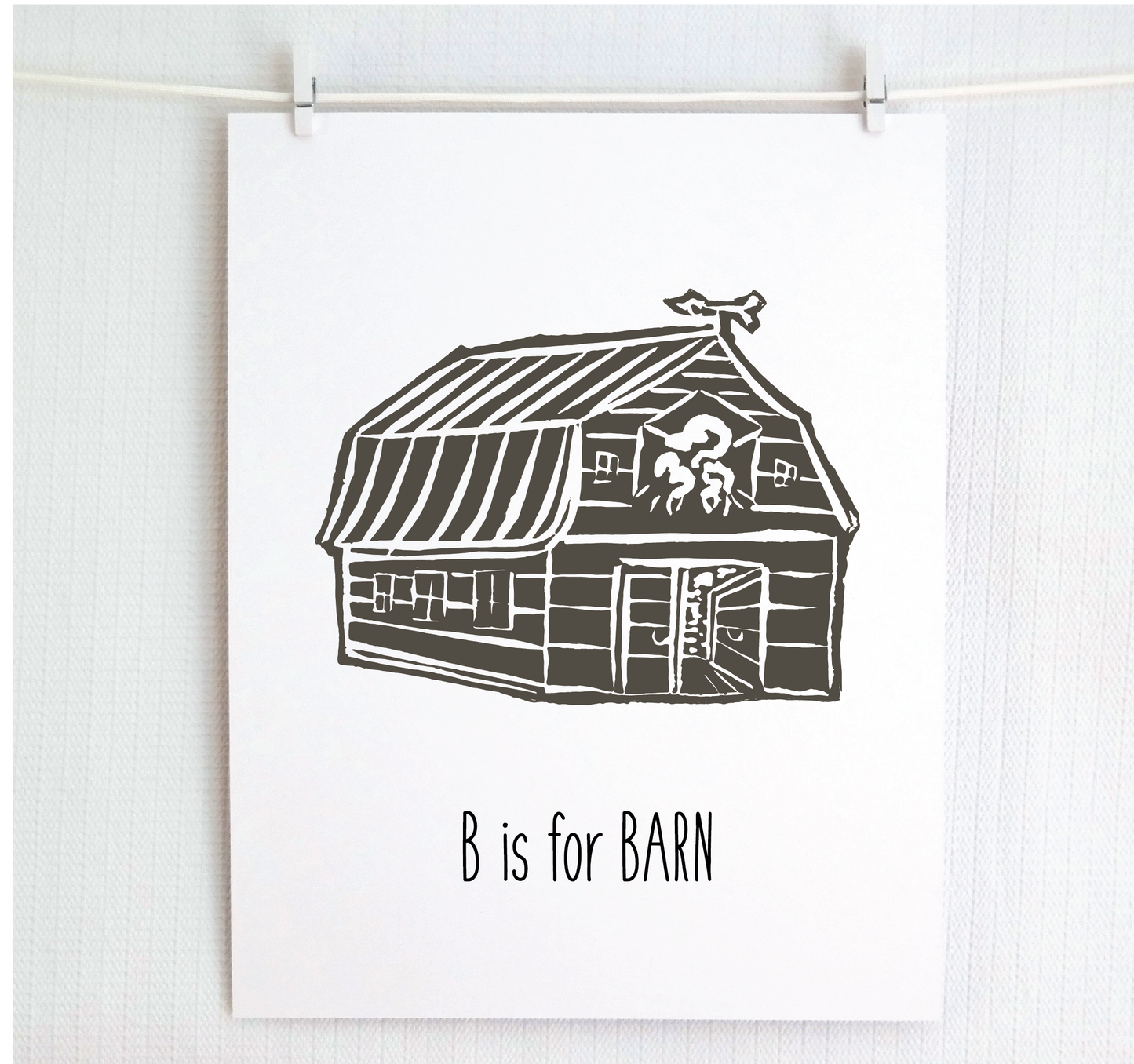 An illustrated barn with stands with an open door and arrow weathervane over hand written style, thin block lettering text that says “B for Barn.”
