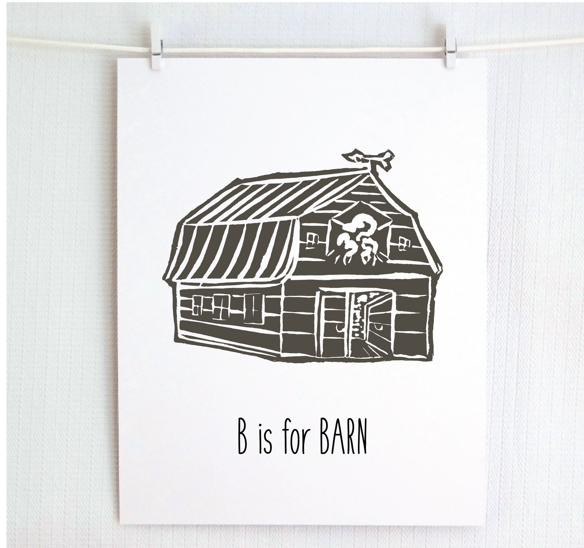 An illustrated barn with stands with an open door and arrow weathervane over hand written style, thin block lettering text that says “B for Barn.”
