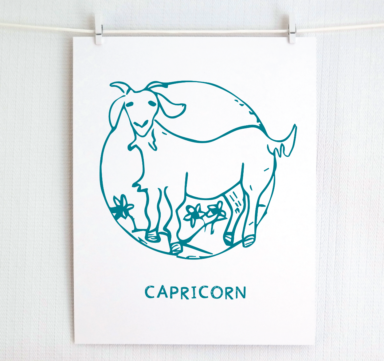 An illustration of the CAPRICORN Zodiac sign as a goat, printed on paper with the word ‘CAPRICORN’ at the bottom in dark teal.