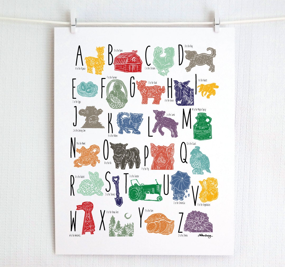 A colorful woodblock print alphabet poster featuring illustrations of farm animals, displayed on a white wall.
