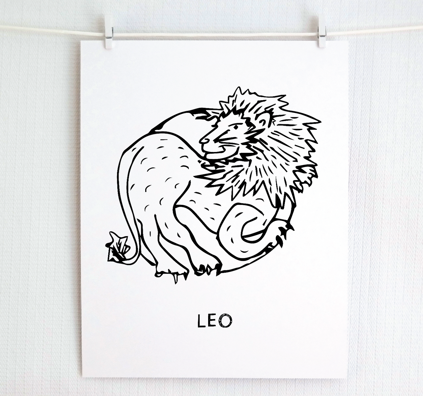 An illustration of the LEO Zodiac sign as a lion, printed on paper with the word ‘LEO’ at the bottom.