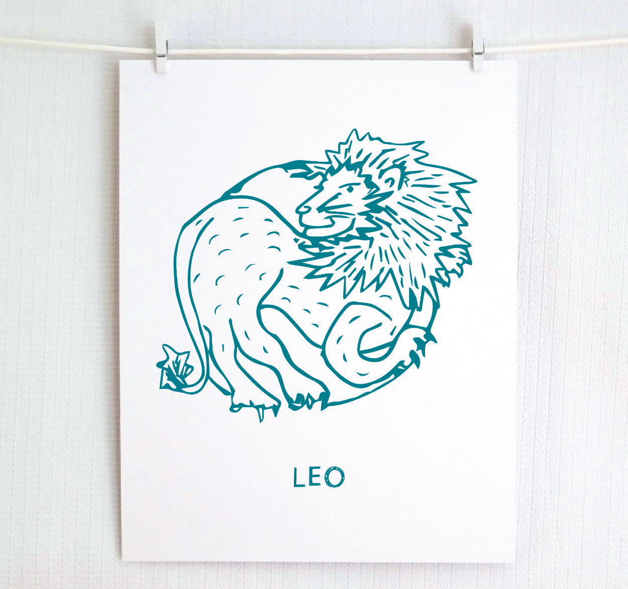 An illustration of the LEO Zodiac sign as a lion, printed on paper with the word ‘LEO’ at the bottom in dark teal.