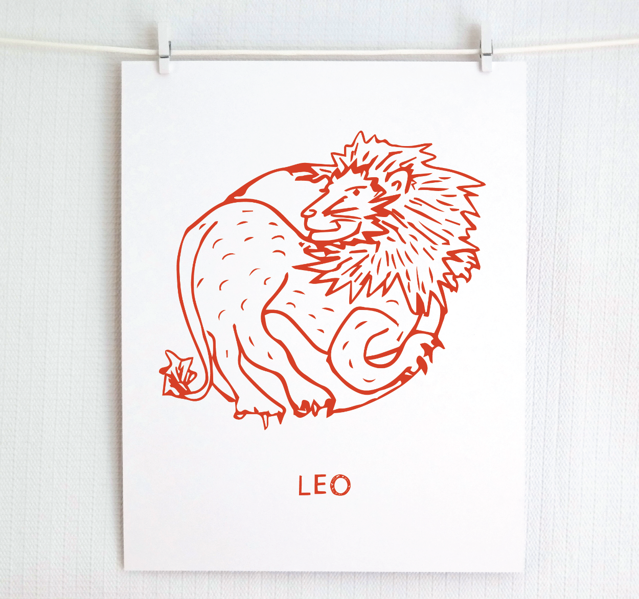 An illustration of the LEO Zodiac sign as a lion, printed on paper with the word ‘LEO’ at the bottom in red.