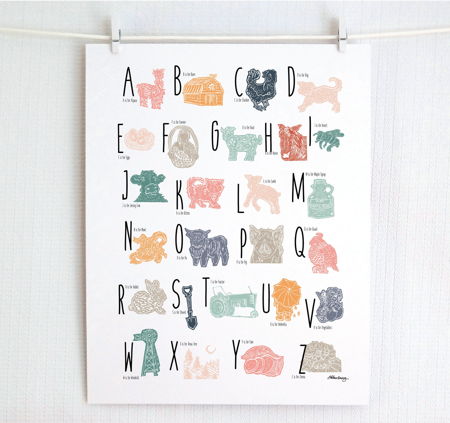 A colorful woodblock print alphabet poster featuring illustrations of farm animals, displayed on a white wall.