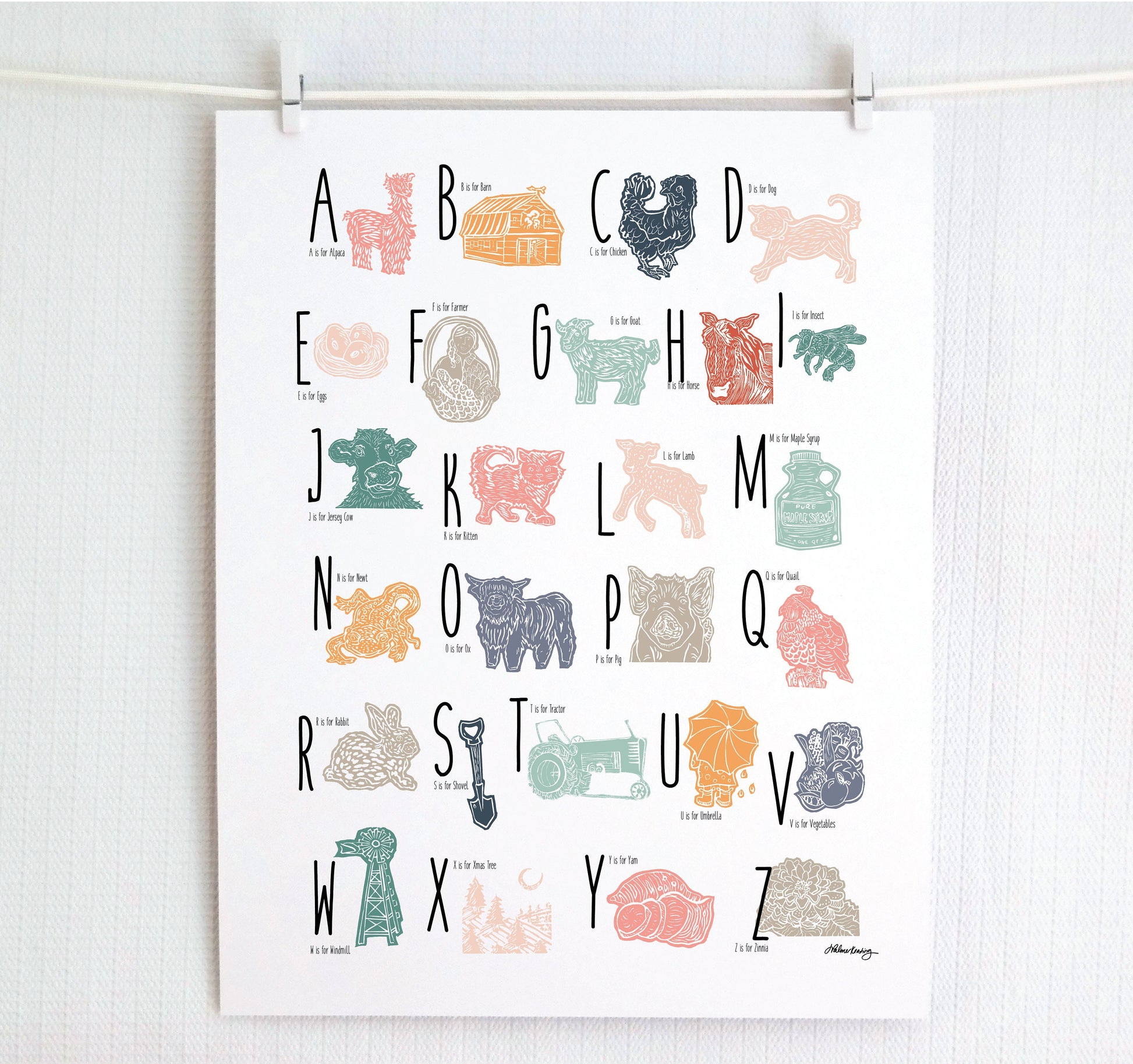A colorful woodblock print alphabet poster featuring illustrations of farm animals, displayed on a white wall.