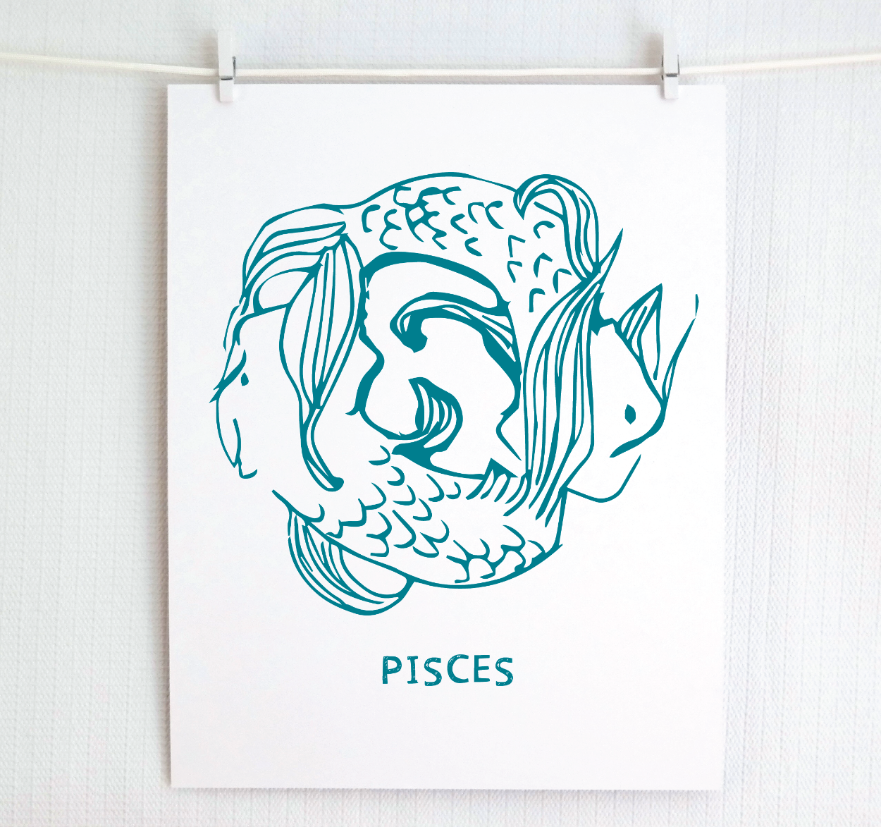 Framed Pisces zodiac art in dark teal.