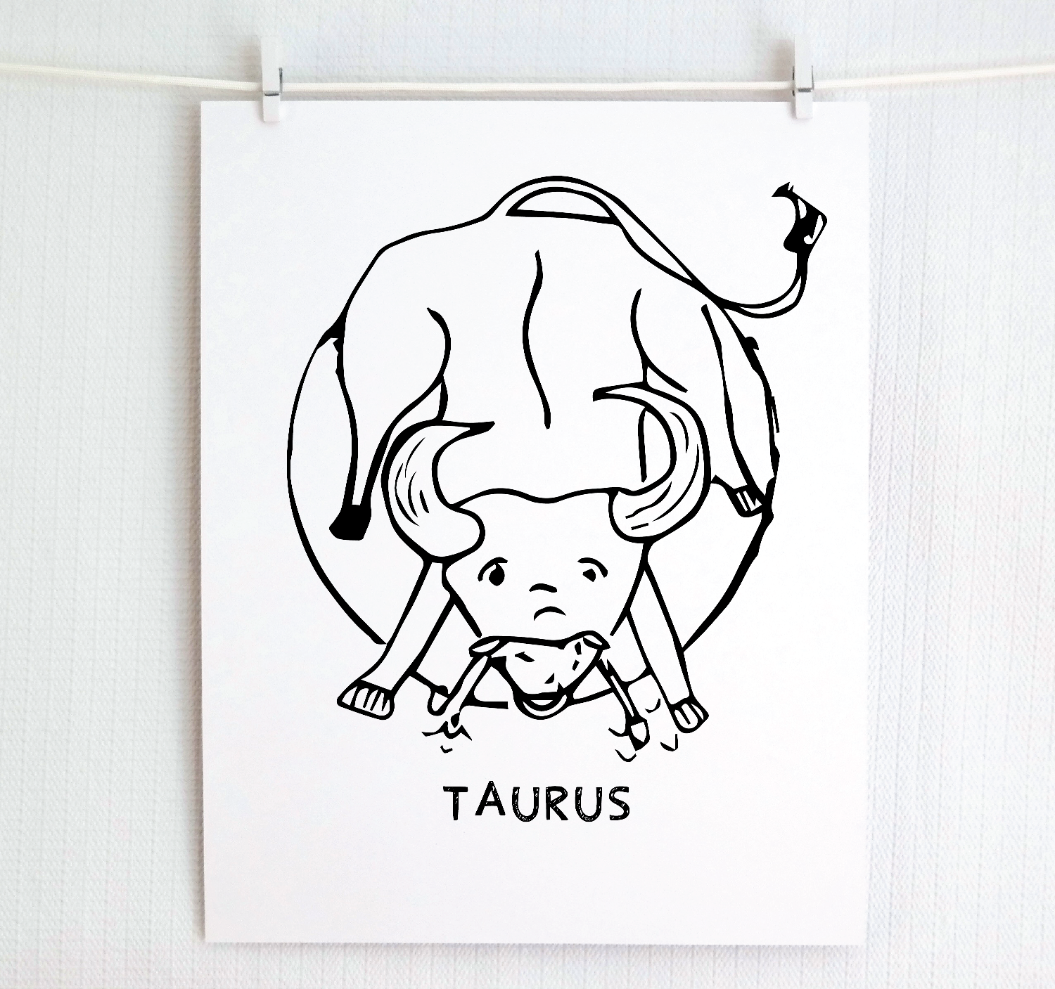 An illustration of the TAURUS Zodiac sign as a bull, printed on paper with the word ‘TAURUS’ at the bottom.