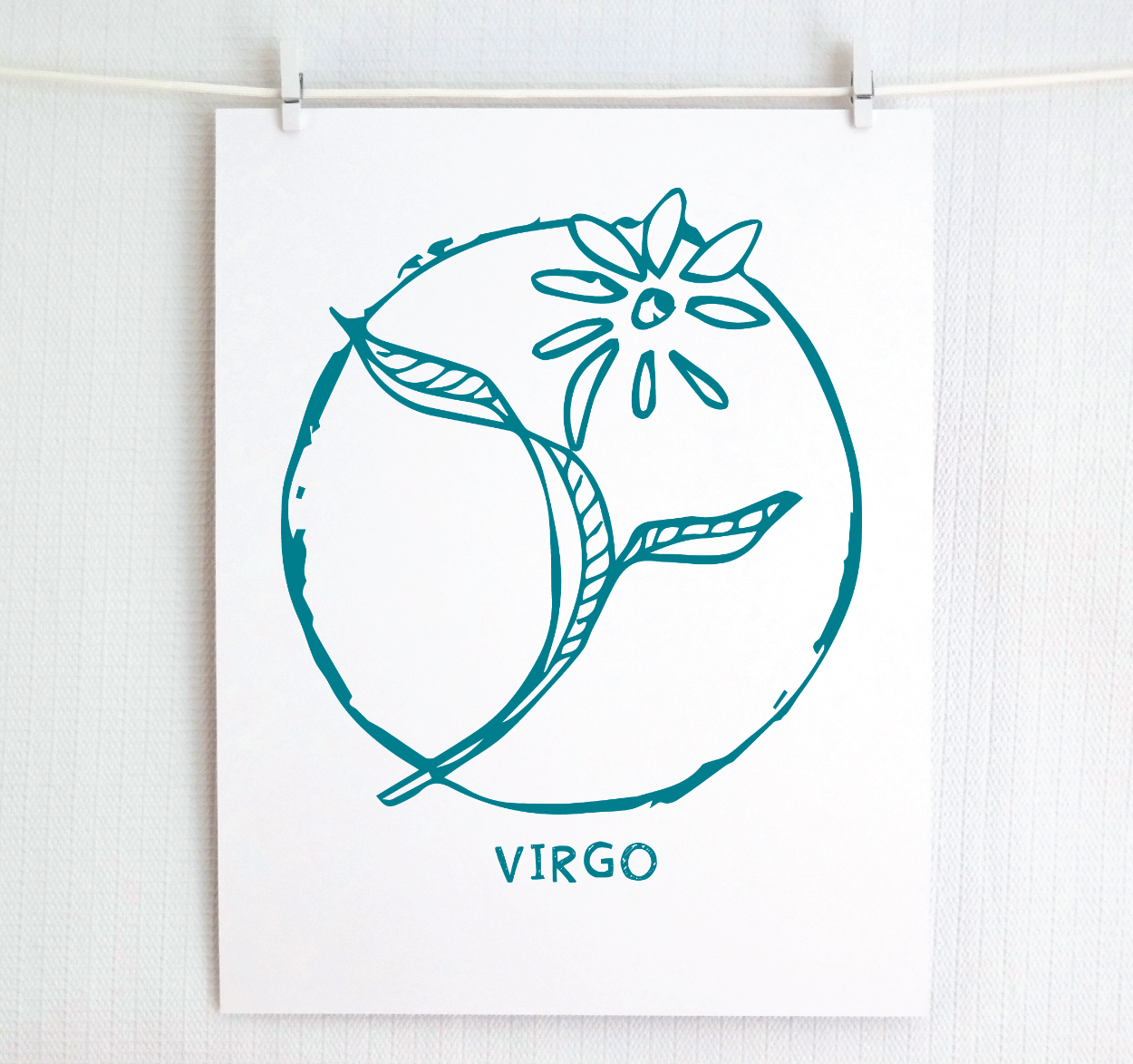 An illustration of the VIRGO Zodiac sign as a flower, printed on paper with the word ‘VIRGO’ at the bottom in dark teal.