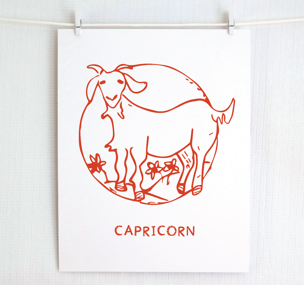 An illustration of the CAPRICORN Zodiac sign as a goat, printed on paper with the word ‘CAPRICORN’ at the bottom in red.